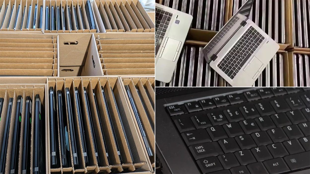 Rows of used business laptops packed in protective cardboard dividers for IT asset recovery, laptop buyback, and electronics resale services.