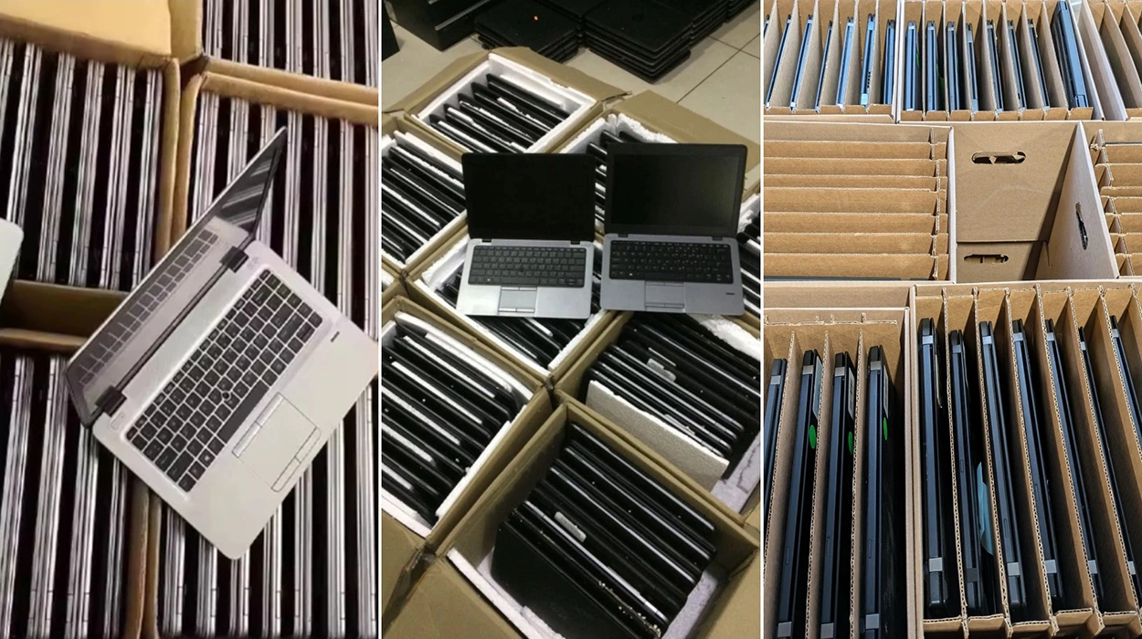Used laptops organized in bulk shipping boxes and protective cardboard dividers for IT asset disposition (ITAD), resale, refurbishment, and used computer equipment valuation services.