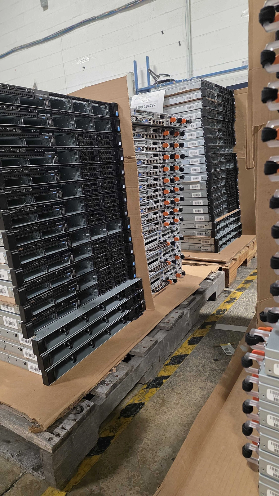 Decommissioned enterprise servers organized for inspection and buyback processing